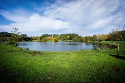 Scenic view of lake against cloudy sky