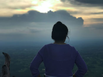 Rear view of man looking at sunset