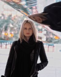 Portrait of smiling young woman standing outdoors