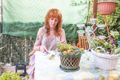 Middle-aged caucasian woman casts tarot cards for a tarot reading.