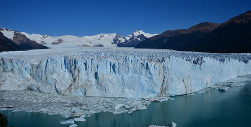 Scenic view of frozen lake against mountain range