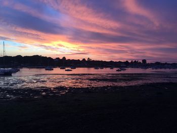 Scenic view of sea against dramatic sky during sunset