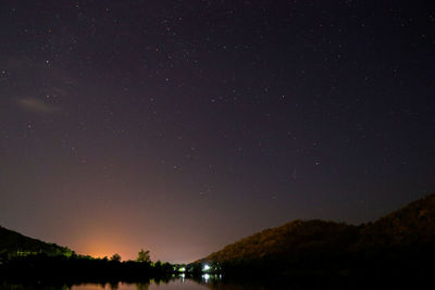 Scenic view of silhouette mountain against sky at night