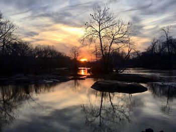 Scenic view of frozen lake against sky during sunset