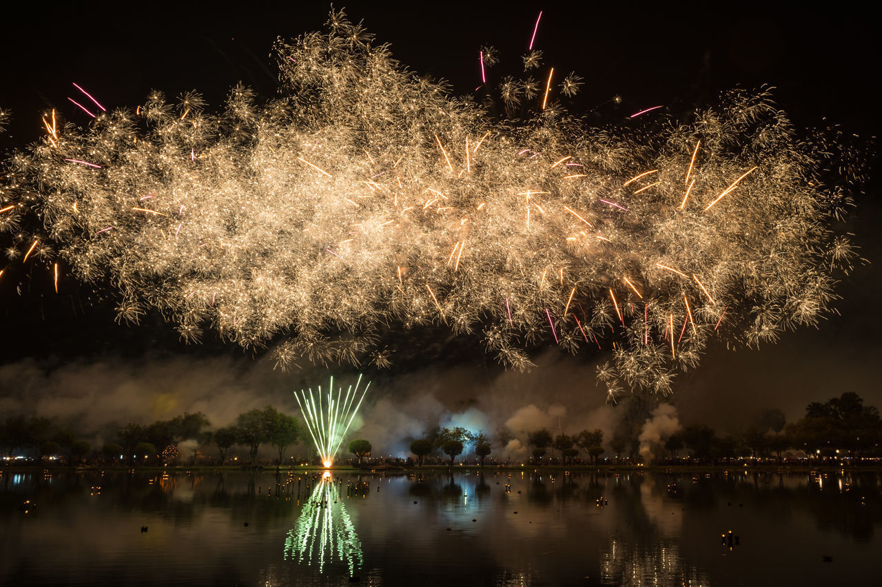 FIREWORK DISPLAY OVER LAKE AGAINST SKY AT NIGHT