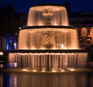 Illuminated fountain at night