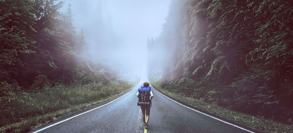 Rear view of man walking in water