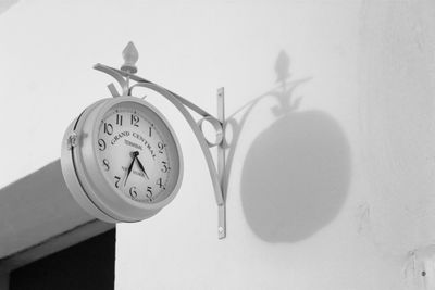 Low angle view of clock on wall