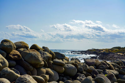 Rocks on beach against sky