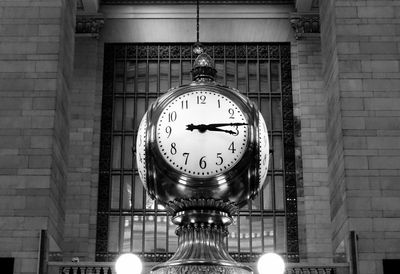 Low angle view of illuminated clock