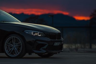 Close-up of vintage car on road at sunset