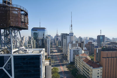 Modern buildings in city against clear sky