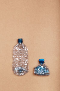 Empty plastic bottles put in a row, over cardboard background. collecting plastic waste to recycling