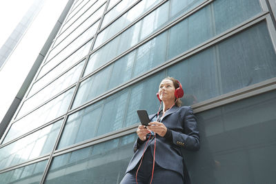 Low angle view of man using mobile phone in building