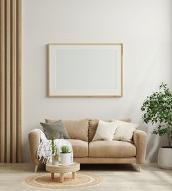 Poster frame mockup in scandinavian style living room interior.3d rendering