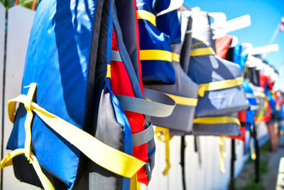 Row of colorful water safety life jackets