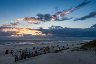 Scenic view of beach against sky during sunset