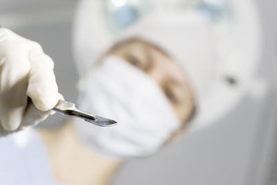 Close-up of doctor holding medical equipment