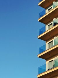 Low angle view of building against clear blue sky