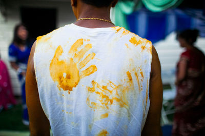 Rear view of man holding ice cream