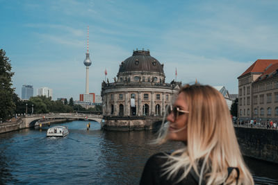 Mid adult woman against buildings in city