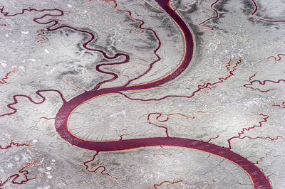 High angle view of red river within salt pond