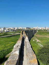 Panoramic view of city against clear blue sky