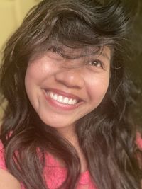 Close-up portrait of a smiling young woman