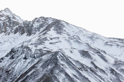 Scenic view of snowcapped mountains against clear sky