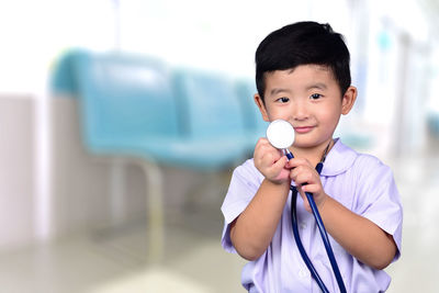 Portrait of boy holding camera