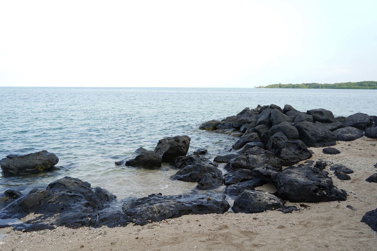 SCENIC VIEW OF ROCKS ON BEACH AGAINST SKY