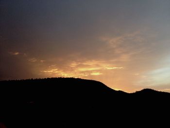 Scenic view of silhouette mountains against sky at sunset