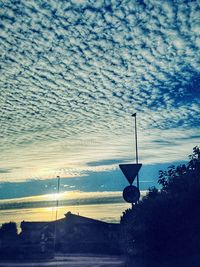 Street light against cloudy sky