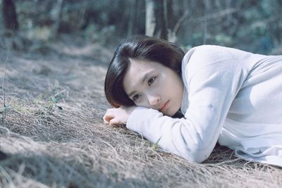 Portrait of young woman lying on floor