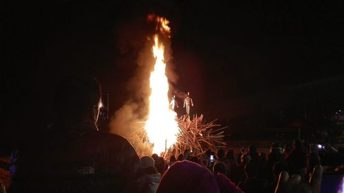 People watching firework display at night