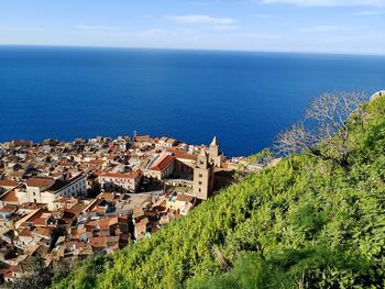 High angle view of sea by tree against sky