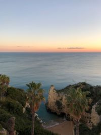 Scenic view of sea against clear sky at sunset