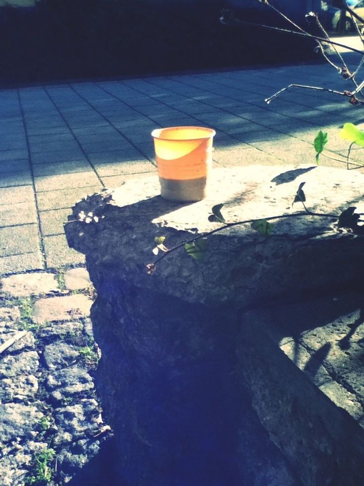 drink, sunlight, high angle view, water, shadow, day, outdoors, no people, table, rock - object, close-up, refreshment, food and drink, blue, still life, absence, sea, nature, auto post production filter, wood - material