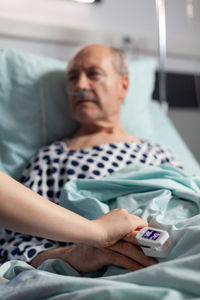 Midsection of man lying on bed