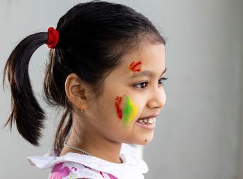 Portrait of a cute indian girl child with colorful cheek