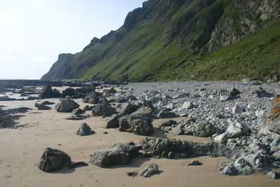 Rocks on beach against sky