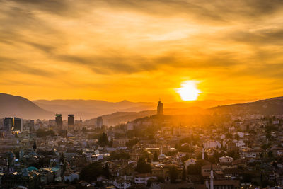 Aerial view of townscape against sky during sunset