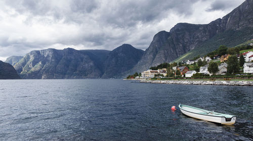 Scenic view of sea and mountains against sky