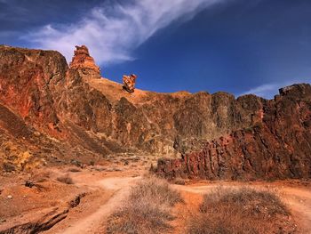 Rock formations on landscape against sky