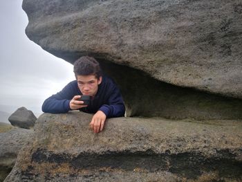 Portrait of young man on rock