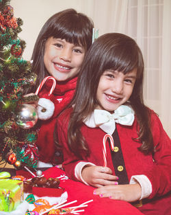 Portrait of smiling mother and daughter at home