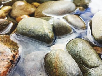 Close-up of pebbles in water