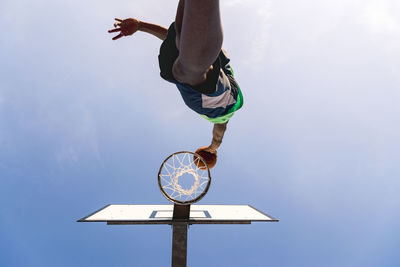 Low angle view of man skateboarding against sky