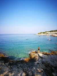 Scenic view of sea against clear blue sky