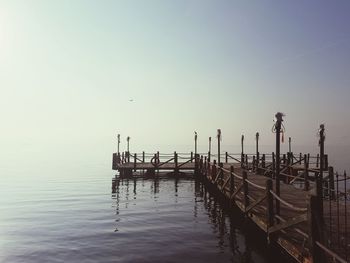 Pier over sea against clear sky